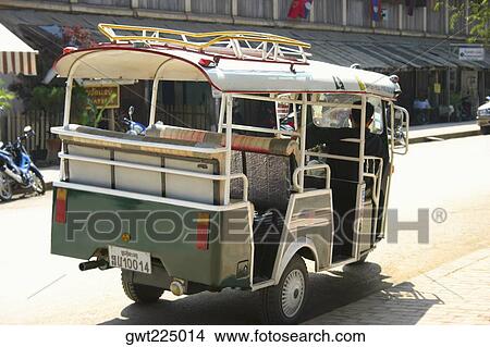 Rear view of a man driving a jinrikisha, Vientiane, Laos View Large Photo Image Picture - Rear view of a man driving a jinrikisha, Vientiane, Laos. Fotosearch