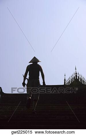 Rear view of a man moving up steps, Vientiane, Laos View Large Photo Image Stock Photography - Rear view of a man moving up steps, Vientiane, Laos. Fotosearch