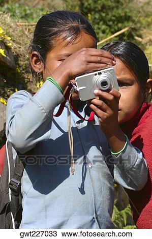 Close-up of two girls taking a photograph of themselves, Tadapani, Annapurna Range, Himalayas, Nepal View Large Photo Image Stock Image - Close-up of two girls taking a photograph of themselves, Tadapani, Annapurna Range, Himalayas, Nepal. Fotosearch