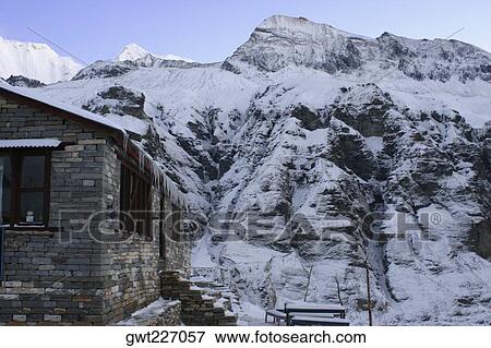 House in front of a snow covered mountain, Annapurna Range, Himalayas, Nepal View Large Photo Image Stock Photo - House in front of a snow covered mountain, Annapurna Range, Himalayas, Nepal. Fotosearch
