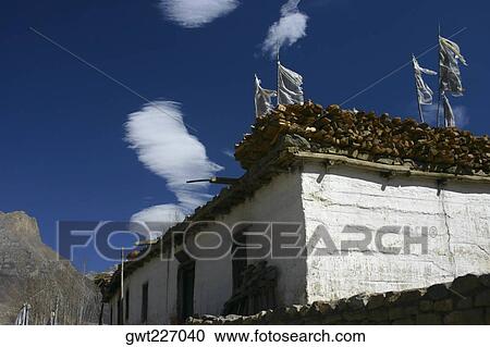 Stock Image - Low angle view of prayer flags fluttering on a house, Muktinath, Annapurna Range, Himalayas, Nepal. Fotosearch