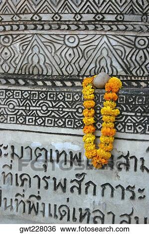 Stock Photograph - Close-up of a garland hanging on a wall, Nong Khai, Thailand. Fotosearch