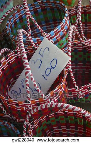 Stock Image - Close-up of wicker baskets with a price tag, Floating Market, Thailand. Fotosearch