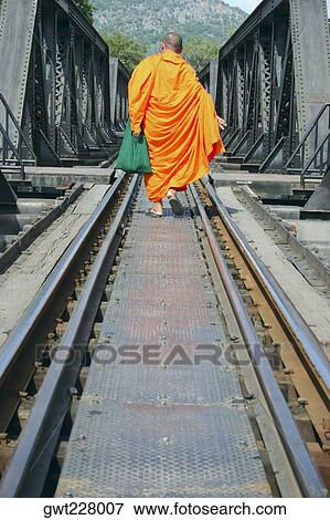 Rear view of a monk walking on a railroad track, Nong Khai, Thailand View Large Photo Image Stock Photo - Rear view of a monk walking on a railroad track, Nong Khai, Thailand. Fotosearch