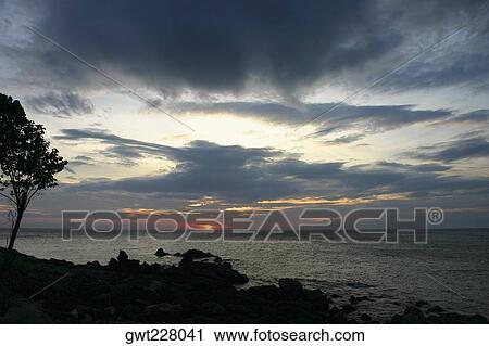 Stock Image - Sunset over the sea, Ko Lanta, Thailand. Fotosearch