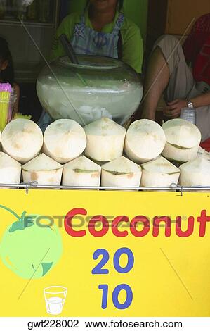 Three people behind a coconut market stall, Bangkok, Thailand View Large Photo Image Stock Image - Three people behind a coconut market stall, Bangkok, Thailand. Fotosearch