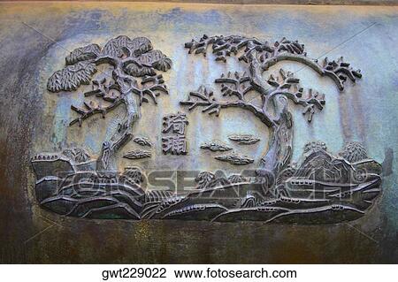 Stock Image - Close-up of carving on a decorative urn, Ho Chi Minh City, Vietnam. Fotosearch