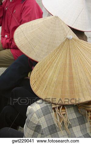Close-up of three people wearing asian style conical hats, Hanoi, Vietnam View Large Photo Image Stock Image - Close-up of three people wearing asian style conical hats, Hanoi, Vietnam. Fotosearch