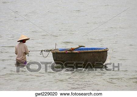 Fisherman in the sea with his tub boat, Hoi An, Vietnam View Large Photo Image Stock Image - Fisherman in the sea with his tub boat, Hoi An, Vietnam. Fotosearch