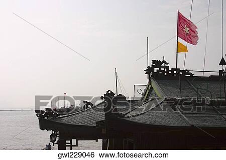 Flag fluttering on a pagoda, Halong Bay, Vietnam View Large Photo Image Stock Photograph - Flag fluttering on a pagoda, Halong Bay, Vietnam. Fotosearch