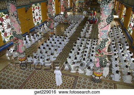 High angle view of a group of people praying in a monastery, Cao Dai Monastery, Tay Ninh, Vietnam View Large Photo Image Stock Photograph - High angle view of a group of people praying in a monastery, Cao Dai Monastery, Tay Ninh, Vietnam. Fotosearch