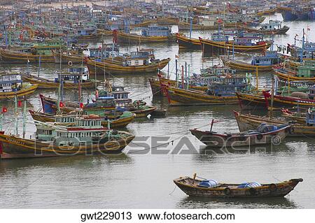 Stock Image - High angle view of boats moored at a harbor, Hoi An, Vietnam. Fotosearch