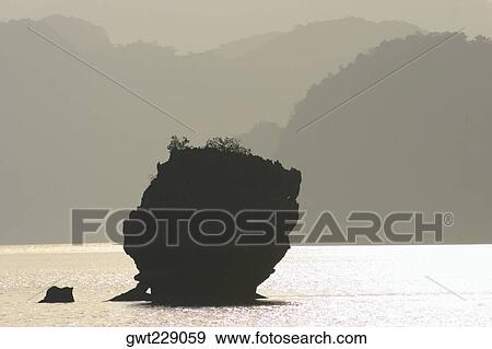 Rock formation in water, Halong Bay, Vietnam View Large Photo Image Stock Photo - Rock formation in water, Halong Bay, Vietnam. Fotosearch