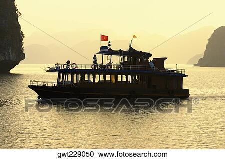 Tourboat in the sea, Halong Bay, Vietnam View Large Photo Image Stock Image - Tourboat in the sea, Halong Bay, Vietnam. Fotosearch