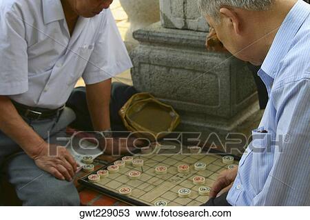Two mature men playing a board game, Hanoi, Vietnam View Large Photo Image Stock Image - Two mature men playing a board game, Hanoi, Vietnam. Fotosearch