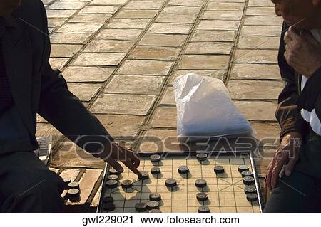 Two men playing a board game, Hanoi, Vietnam View Large Photo Image Stock Image - Two men playing a board game, Hanoi, Vietnam. Fotosearch