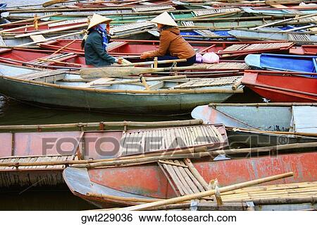 Two women sitting in the boat, Dong Hoi, Vietnam View Large Photo Image Stock Photograph - Two women sitting in the boat, Dong Hoi, Vietnam. Fotosearch