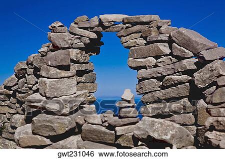 Stock Photograph - Lake viewed through a stone wall, Lake Titicaca, Taquile Island, Puno, Peru. Fotosearch