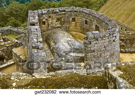 Stock Image - High angle view of the ruins of a temple, Temple of The Sun, Machu Picchu, Urubamba Valley, Cuzco, Peru. Fotosearch