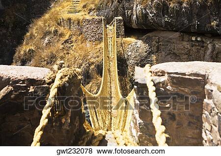 Stock Photo - Rope bridge across a mountain, Queswachaca, Peru. Fotosearch
