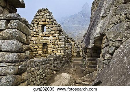 Stock Image - Street passing through the old ruins, Machu Picchu, Cusco Region, Peru. Fotosearch