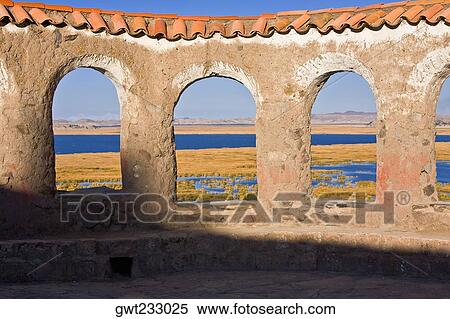 Stock Photography - Sea viewed through windows of a building, Chicuito, Puno, Peru. Fotosearch