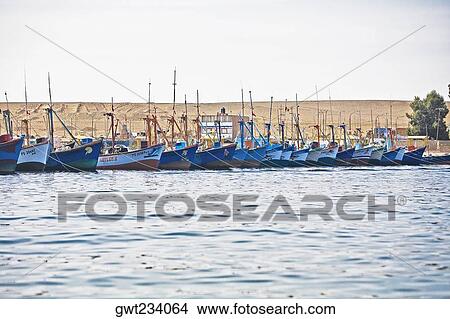 Picture - Boats moored at a harbor, Chaco, Peru. Fotosearch