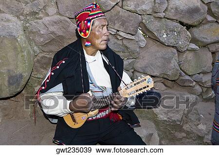 Close-up of a senior man playing a ukulele, Taquile Island, Lake Titicaca, Puno, Peru View Large Photo Image Stock Photo - Close-up of a senior man playing a ukulele, Taquile Island, Lake Titicaca, Puno, Peru. Fotosearch