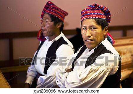 Stock Photograph - Close-up of two young men taking part in a wedding ceremony, Taquile Island, Lake Titicaca, Puno, Peru. Fotosearch