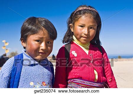 Portrait of a girl with a boy, Taquile Island, Lake Titicaca, Puno, Peru View Large Photo Image Picture - Portrait of a girl with a boy, Taquile Island, Lake Titicaca, Puno, Peru. Fotosearch