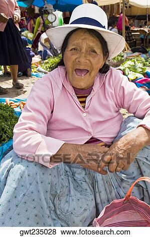 Portrait of a senior woman crouching at a market stall, Peru View Large Photo Image Stock Photo - Portrait of a senior woman crouching at a market stall, Peru. Fotosearch