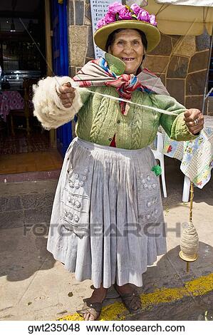 Portrait of a senior woman standing and holding a spool of thread, Peru View Large Photo Image Stock Photo - Portrait of a senior woman standing and holding a spool of thread, Peru. Fotosearch
