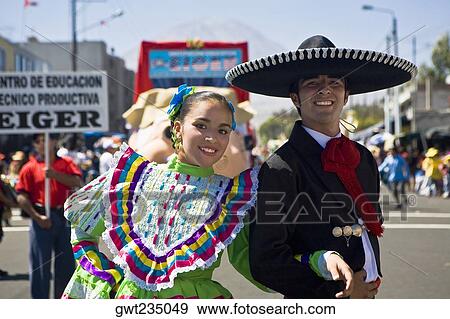 Portrait of a young couple with arm in arm in a parade, Arequipa, Peru View Large Photo Image Stock Photo - Portrait of a young couple with arm in arm in a parade, Arequipa, Peru. Fotosearch