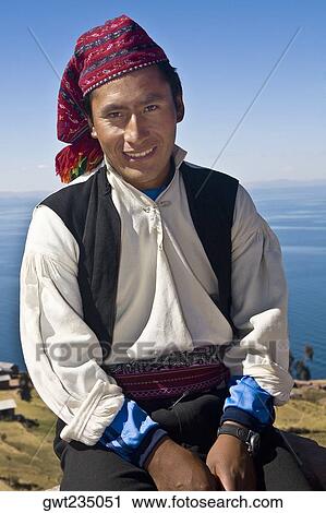 Portrait of a young man sitting and smiling, Taquile Island, Lake Titicaca, Puno, Peru View Large Photo Image Stock Image - Portrait of a young man sitting and smiling, Taquile Island, Lake Titicaca, Puno, Peru. Fotosearch