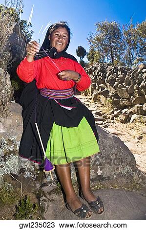 Portrait of a young woman spinning a reel of thread, Taquile Island, Lake Titicaca, Puno, Peru View Large Photo Image Stock Image - Portrait of a young woman spinning a reel of thread, Taquile Island, Lake Titicaca, Puno, Peru. Fotosearch