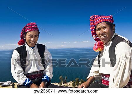 Portrait of two young men sitting, Taquile Island, Lake Titicaca, Puno, Peru View Large Photo Image Stock Image - Portrait of two young men sitting, Taquile Island, Lake Titicaca, Puno, Peru. Fotosearch