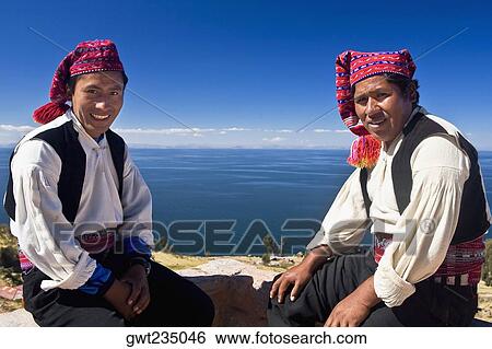 Portrait of two young men sitting, Taquile Island, Lake Titicaca, Puno, Peru View Large Photo Image Stock Photograph - Portrait of two young men sitting, Taquile Island, Lake Titicaca, Puno, Peru. Fotosearch