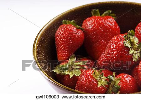 Close-up of a bowl of strawberries View Large Photo Image Stock Image - Close-up of a bowl of strawberries. Fotosearch