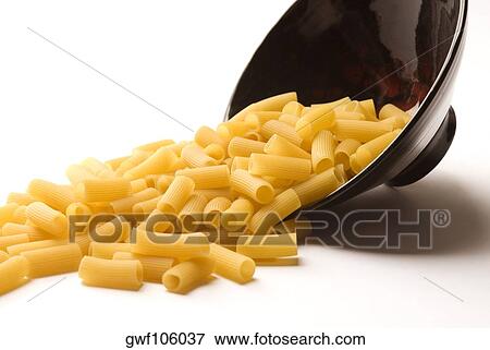 Close-up of a spilled bowl of raw rigatoni pasta View Large Photo Image Stock Photo - Close-up of a spilled bowl of raw rigatoni pasta. Fotosearch