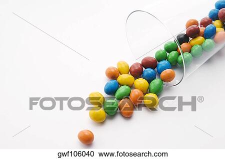 Close-up of candies spilling from a glass View Large Photo Image Stock Image - Close-up of candies spilling from a glass. Fotosearch