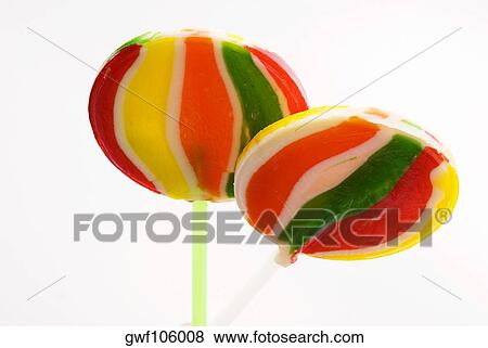 Close-up of two lollipops View Large Photo Image Stock Photo - Close-up of two lollipops. Fotosearch