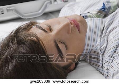 Close-up of a businessman lying on the bed View Large Photo Image Stock Photo - Close-up of a businessman lying on the bed. Fotosearch