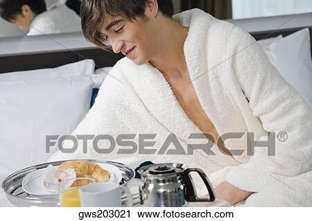 Young man having breakfast View Large Photo Image Stock Image - Young man having breakfast. Fotosearch