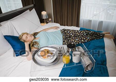 Young woman sleeping on the bed View Large Photo Image Stock Photography - Young woman sleeping on the bed. Fotosearch