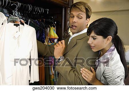 Side profile of a mid adult man with a young woman choosing a dress in a clothing store View Large Photo Image Stock Image - Side profile of a mid adult man with a young woman choosing a dress in a clothing store. Fotosearch