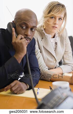 Stock Image - Businessman talking on a phone. Fotosearch