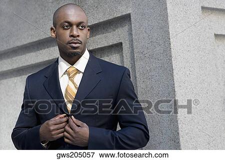 Close-up of a businessman buttoning his coat View Large Photo Image Stock Photo - Close-up of a businessman buttoning his coat. Fotosearch