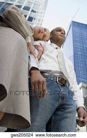 Low angle view of a businesswoman with her head on a businessman's shoulder View Large Photo Image Picture - Low angle view of a businesswoman with her head on a businessman's shoulder. Fotosearch