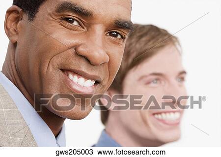 Portrait of a businessman smiling with another businessman smiling beside him View Large Photo Image Stock Image - Portrait of a businessman smiling with another businessman smiling beside him. Fotosearch