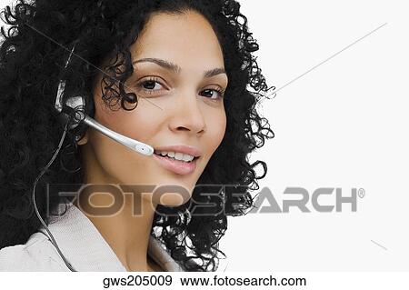 Portrait of a female customer service representative wearing a headset View Large Photo Image Stock Photo - Portrait of a female customer service representative wearing a headset. Fotosearch
